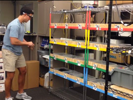 Student in lab picking items from bins using Google Glass